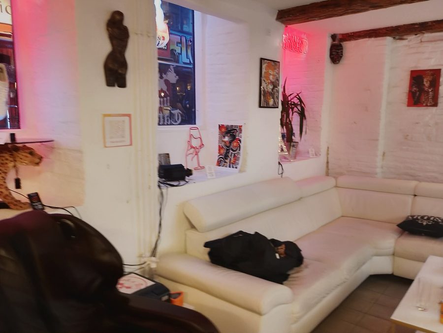 Lounge og venteområde med kunst og neonbelysning hos Ink & Art
